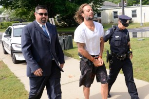 Dylan Eckardt being led to his arraingment