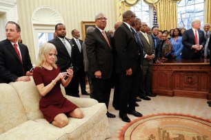 Photos of White House adviser Kellyanne Conway kneeling on an Oval Office couch with her shoes on have sparked an online debate about decorum in the executive mansion.
