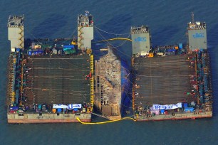 The sunken Sewol ferry is lifted to the surface of the water off the southwestern island of Jindo.