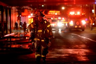 A Jersey City firefighter walks away from the site of a fire that broke out under a bridge in Jersey City on Sept 29.