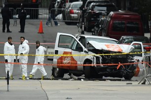 Investigators work around the wreckage of a Home Depot pickup truck a day after it was used in a terror attack in Manhattan on Nov. 1.