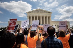 People protest the Muslim travel ban outside of the US Supreme Court in Washington.