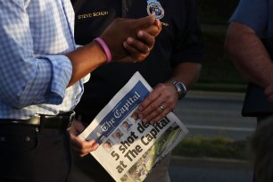 Anne Arundel County Executive Steven Schuh holds today's edition of the Capital Gazette.