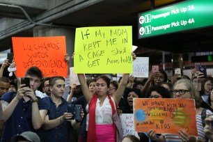 People gather in protest at LaGuardia Airport.