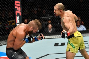 Jose Aldo (right) drops Jeremy Stevens with a punch to the body during their fight at UFC on Fox 30.