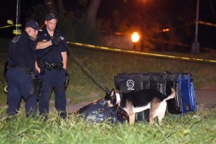 Police at the scene where human remains were found in a bag inside Crotona Park in the Bronx.