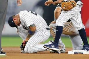 Gleyber Torres holds his hand after getting spiked during a play at second base during the Yankees' 4-1 loss Wednesday night.