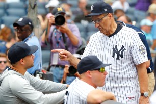 Joe Torre talks with Gary Sanchez before the Yankees' 11-6 win Saturday.