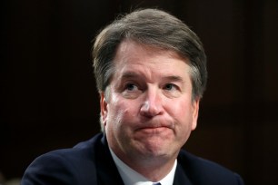 Brett Kavanaugh reacts as he testifies after questioning before the Senate Judiciary Committee.