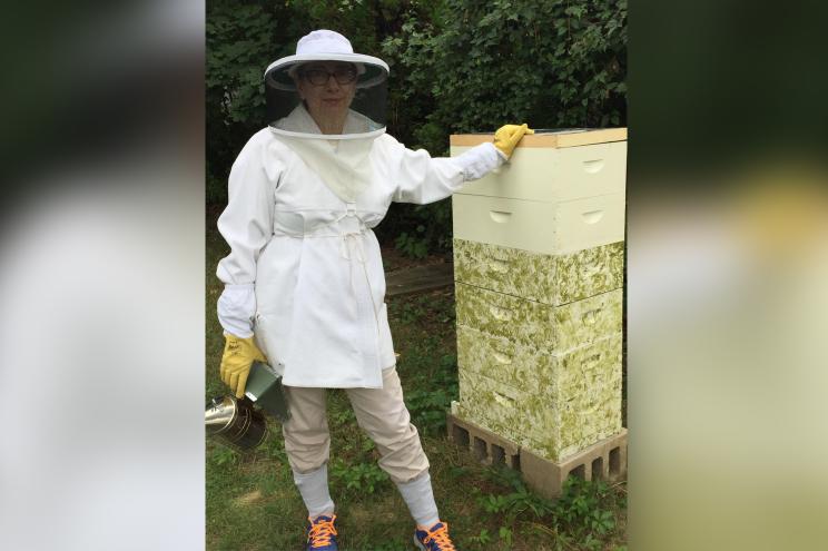 Daryl Altman next to her backyard beehive.