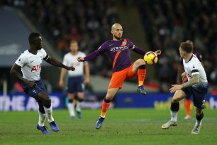 Manchester City's David Silva (center) takes on Tottenham's Davinson Sanchez (left) and Kieran Trippier (right)