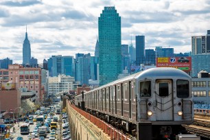 Train approaching elevated subway station in Queens, New York.