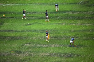 Players of Lobos BUAP inspect the field at Azteca Stadium on Nov. 10.