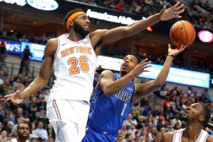 Mitchell Robinson contests Dennis Smith Jr. 's shot during the Knicks' 118-106 win Friday night.