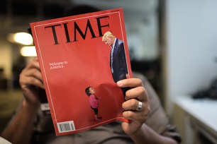 An AFP journalists reads a copy of Time Magazine.