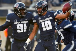 Utah State's Tipa Galeai and Devon Anderson celebrate after an interception.