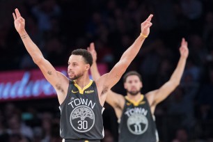 Stephen Curry and a Klay Thompson celebrate during a Warriors victory.