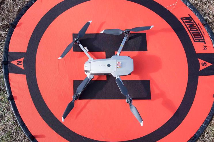 A DJI Mavic Pro quadcopter drone on landing pad.