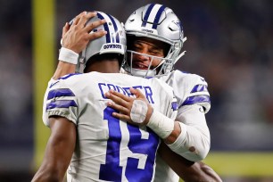 Cowboys quarterback Dak Prescott and wide receiver Amari Cooper celebrate after a touchdown.