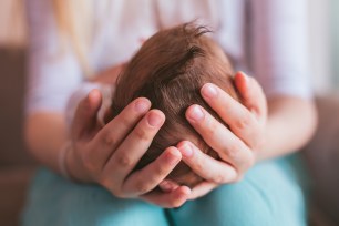 Mom cradles baby's head