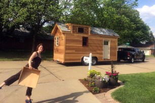 Meghan Panu poses in front of her tiny St. Louis house.