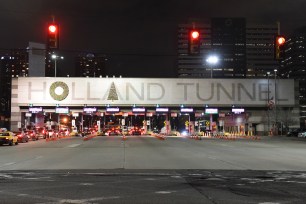 The decorations have new placement on the Holland Tunnel sign.