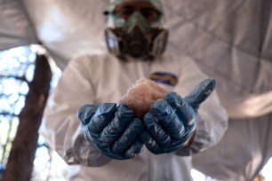 A Mexican Army expert shows crystal meth paste at a clandestine laboratory in Tecate, Mexico.