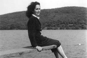 A young Maura Clarke resting on a diving board on a lake