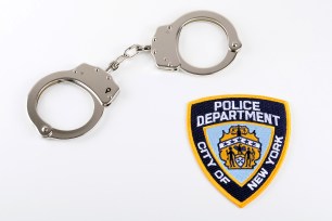 A pair of handcuffs and an NYPD arm patch