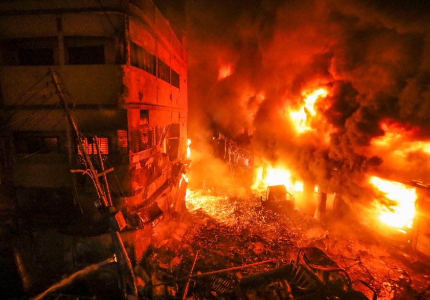 A devastating fire raced through at least five buildings in an old part of Bangladesh's capital and killed scores of people.