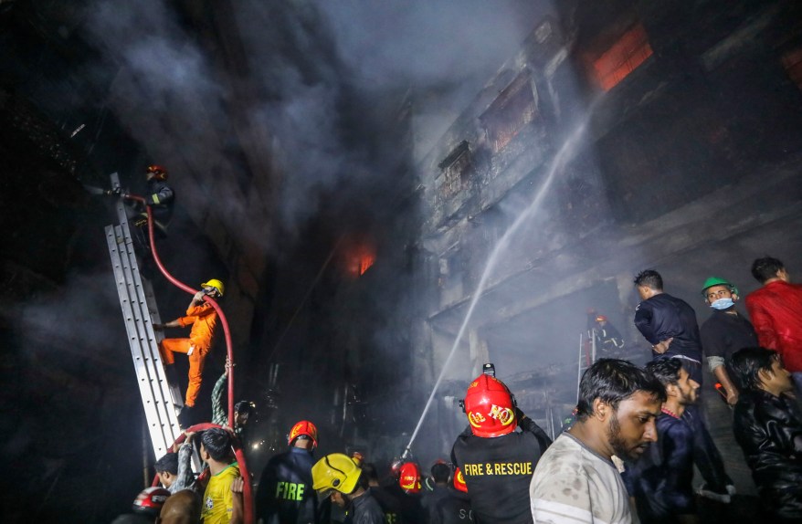 Firefighters work to douse flames in Dhaka, Bangladesh, Thursday, Feb. 21, 2019.