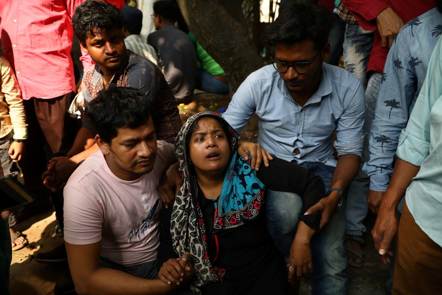 Relatives of victims of a fire incident react while attempting to identify the bodies at Dhaka Medical College Hospital in Dhaka, Bangladesh, February 21, 2019.