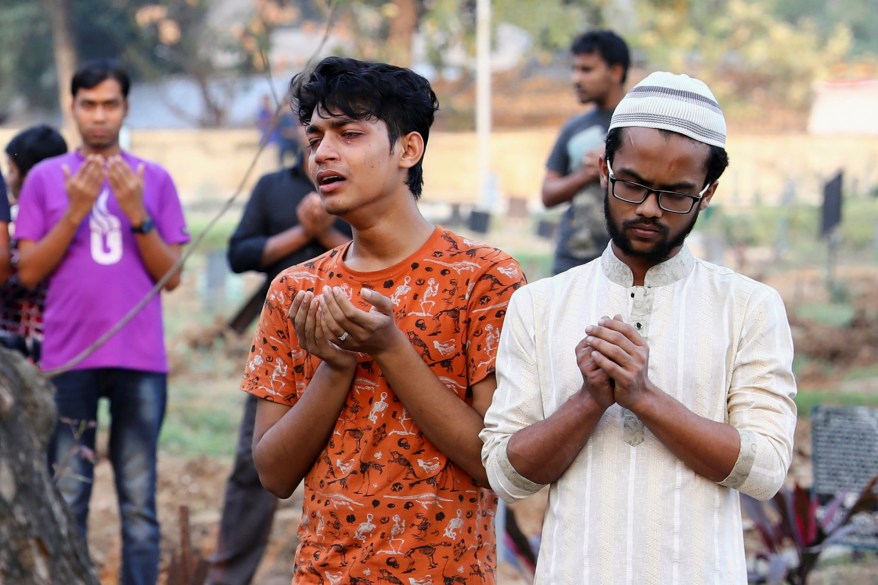 Relatives mourn during the funeral of a person who died in a fire incident at a chemical warehouse, at a graveyard in Dhaka, Bangladesh, February 21, 2019.