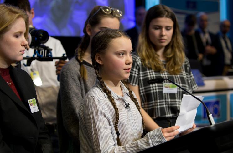 Swedish climate activist Greta Thunberg, center, speaks during an event at the EU Charlemagne building in Brussels.