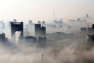 An aerial view of buildings standing out amid haze.