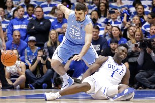 Zion Williamson sprains his right knee after his sneaker exploded when he fell to the floor early in Duke's 88-72 loss to North Carolina on Wednesday night.