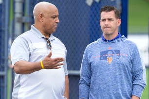 Omar Minaya talks with Brodie Van Wagenen during spring training in February.