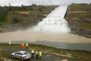 Water flows down the Oroville Dam spillway in Oroville, Calif.