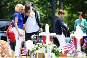 People stop by the memorial in Virginia Beach to pay their respects.