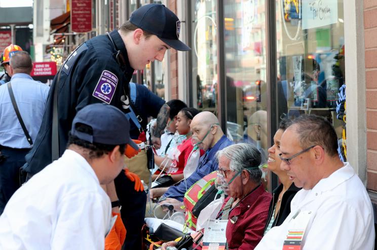 Responders help people affected by carbon monoxide poisoning at St. Malachy's The Actors' Chapel on West 49th Street near Eighth Avenue.