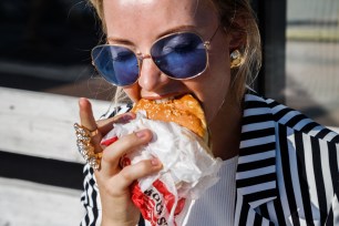 Person eating burger.