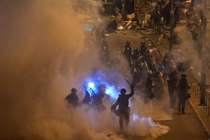 Police fire tear gas at protesters near the government headquarters in Hong Kong.