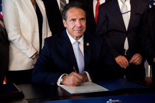 Gov. Andrew Cuomo signs the legislation advancing LaGuardia AirTrain project.