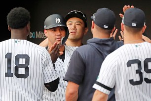 Gary Sanchez high-fives teammates during the seventh inning on Sunday, June 30 in London.