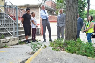 Mayor Bill de Blasio, pictured in the Bronx, announced Tuesday that the homeowners will no longer be on the hook for damaged sidewalks.