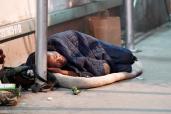 A general view of a homeless person sleeping on a sidewalk in New York