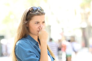 a woman holding her nose