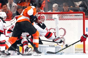 Sean Couturier scores a goal on Cory Schneider during the third period of the Devils' 4-0 loss to the Flyers on Wednesday night.