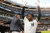 Didi Gregorius raises his arms to the crowd during a curtain call after his grand slam in the third inning of the Yankees' 8-2 win in Game 2 of the ALDS on Saturday.