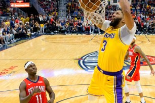 Anthony Davis slams home two of his 41 points during the Lakers' 114-110 win over the Pelicans on Wednesday night.